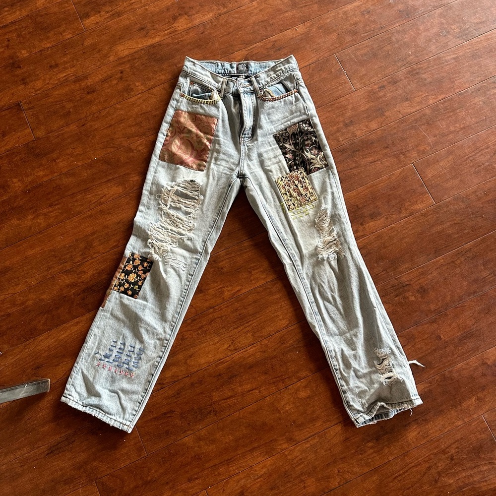 Urban Outfitters "Cowboy Jeans" size 26 with patchwork and rips.